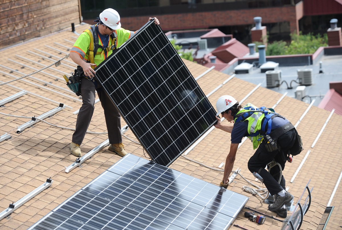 New solar panels being installed on the roof of an affordable-housing apartment complex in Colorado
