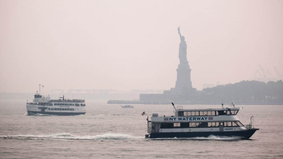 The Statue of Liberty sits behind a cloud of haze from wildfire smoke.
