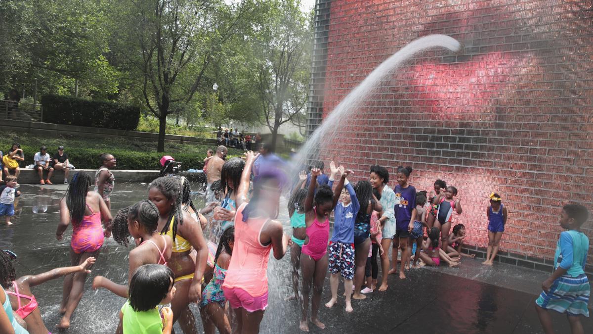 Children cool off in Crown Fountain in downtown Chicago.