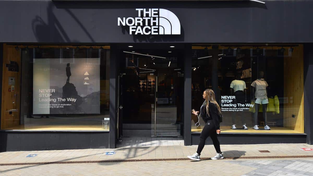 A woman walks past The North Face store in Leeds, England.