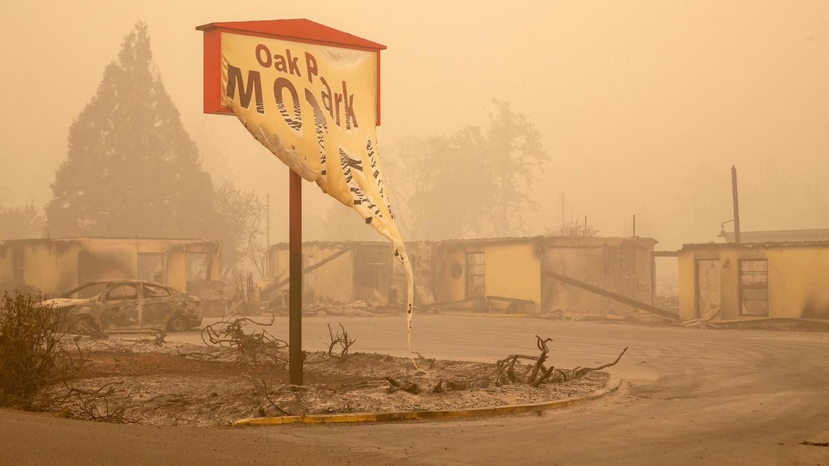 ​A motel sign destroyed by a wildfire in Oregon in 2020.