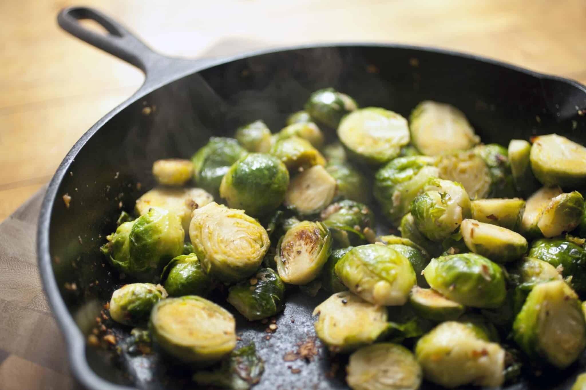 brussels sprouts hot off the stove with steam rising from the pan