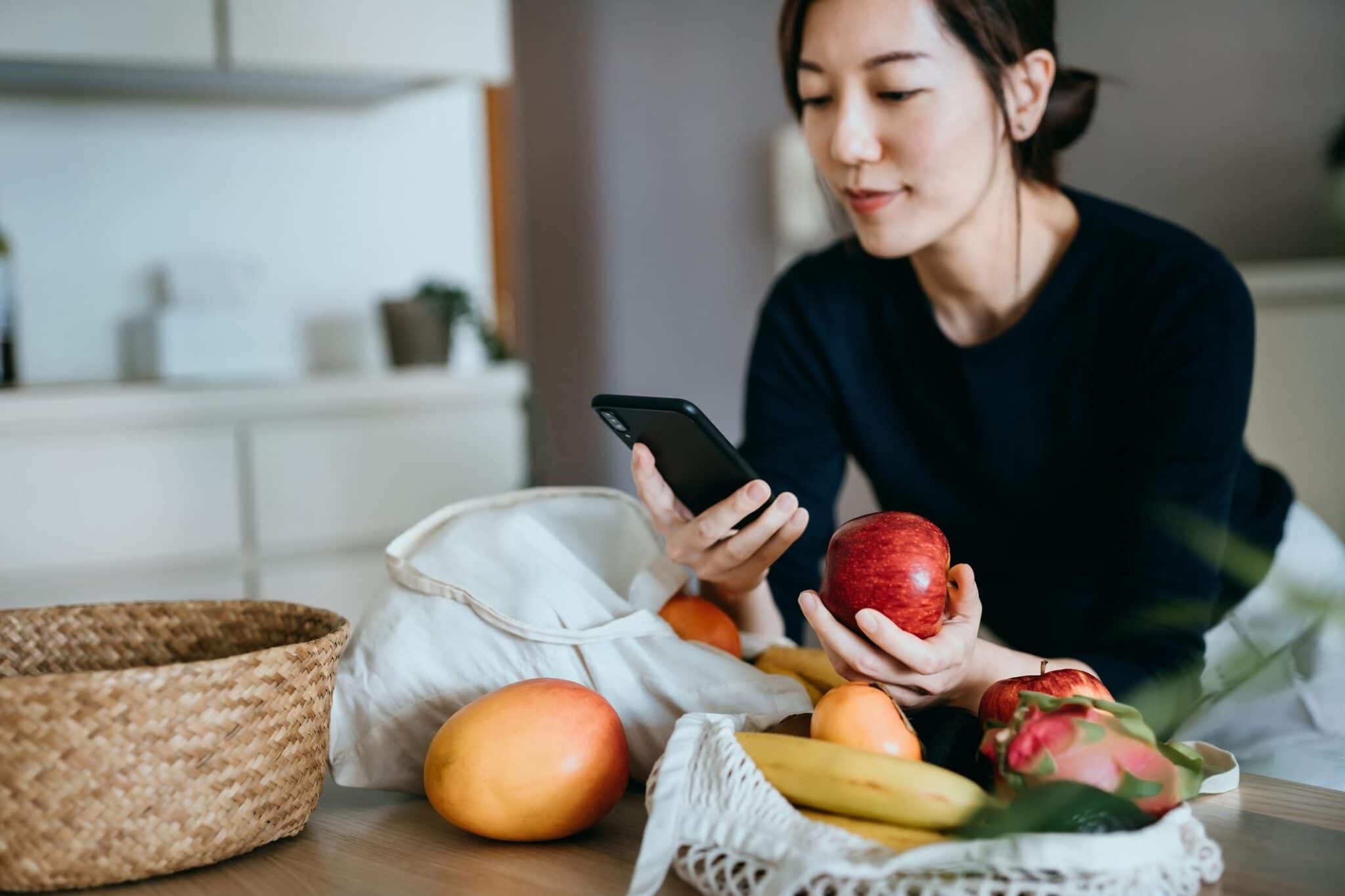 woman looking at smart phone in kitchen