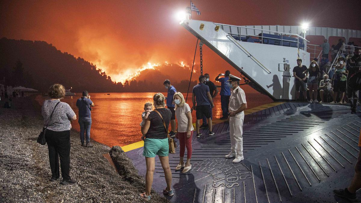 ​People on a ferry evacuating from a wildfire in Greece.