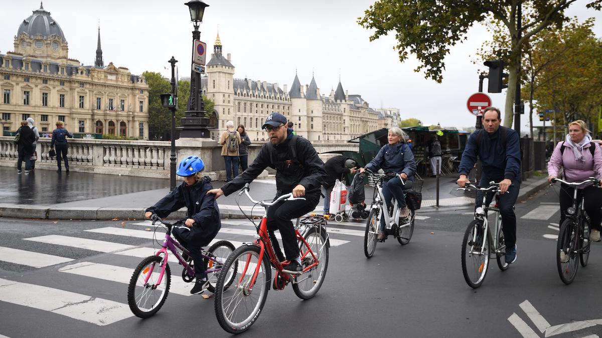 ​People ride bicycles in Paris.