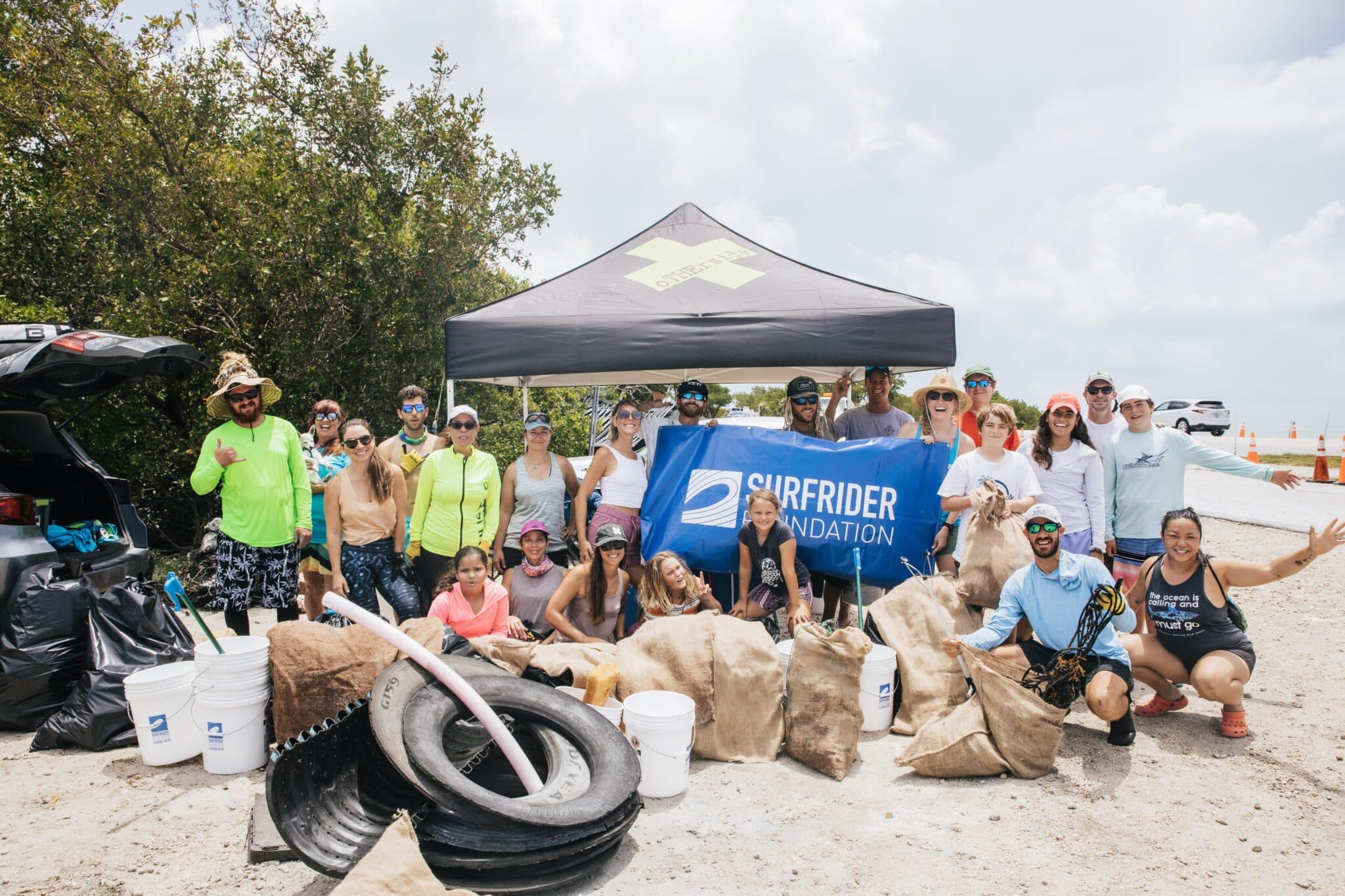 Surfrider Foundation and Florida Keys community members clean up a local mangrove shoreline.