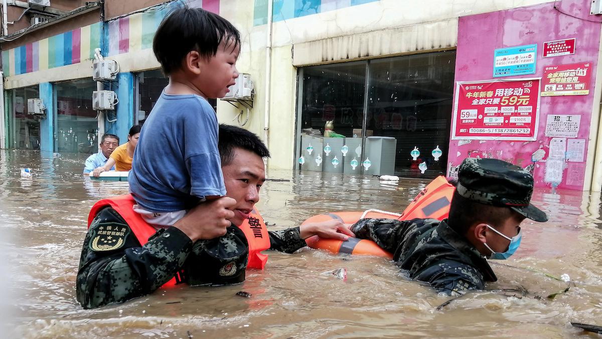 Rescuers evacuate a child from a flood in China.