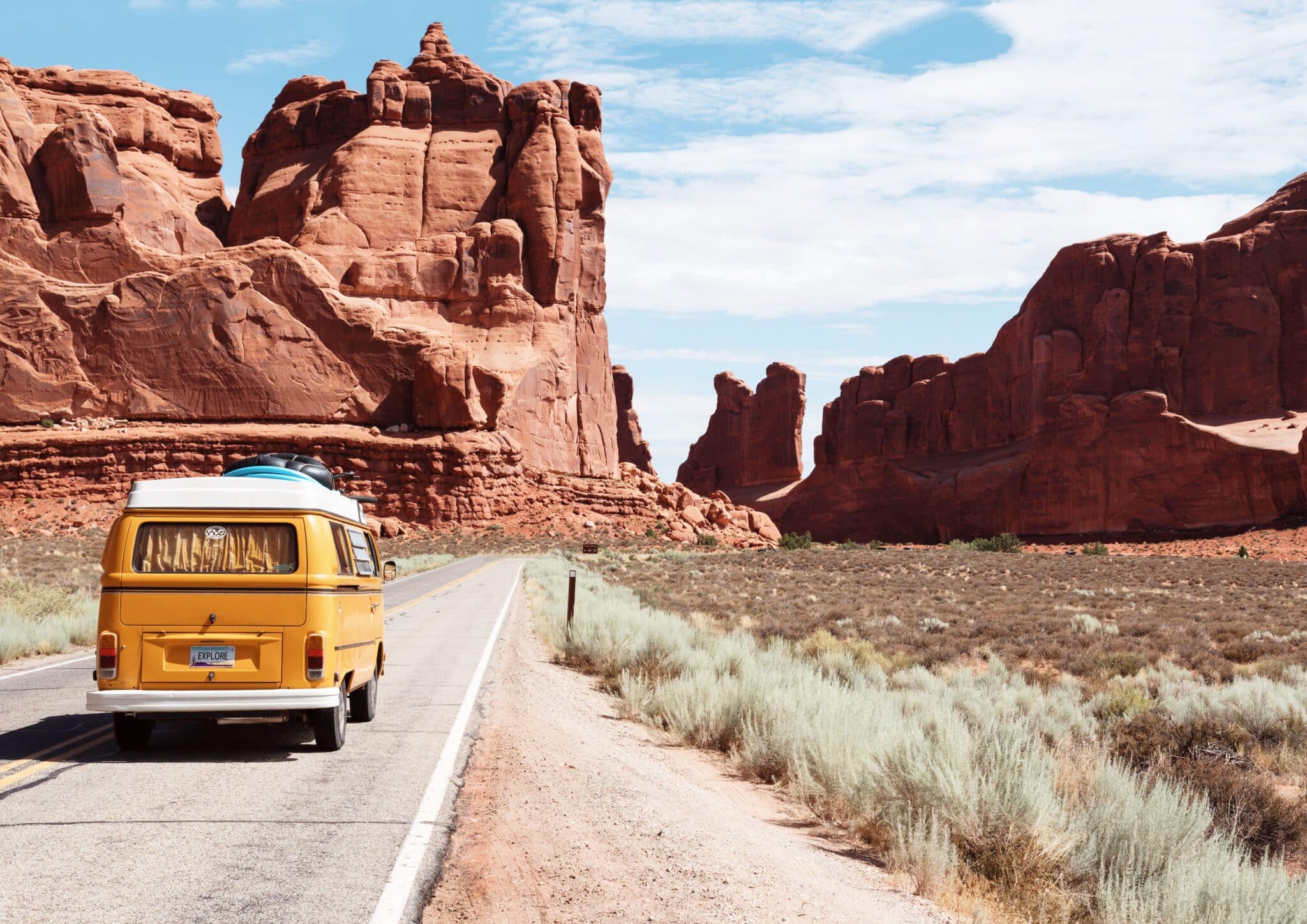 Camper bus taking a road trip through the desert near Arches National Park in Utah