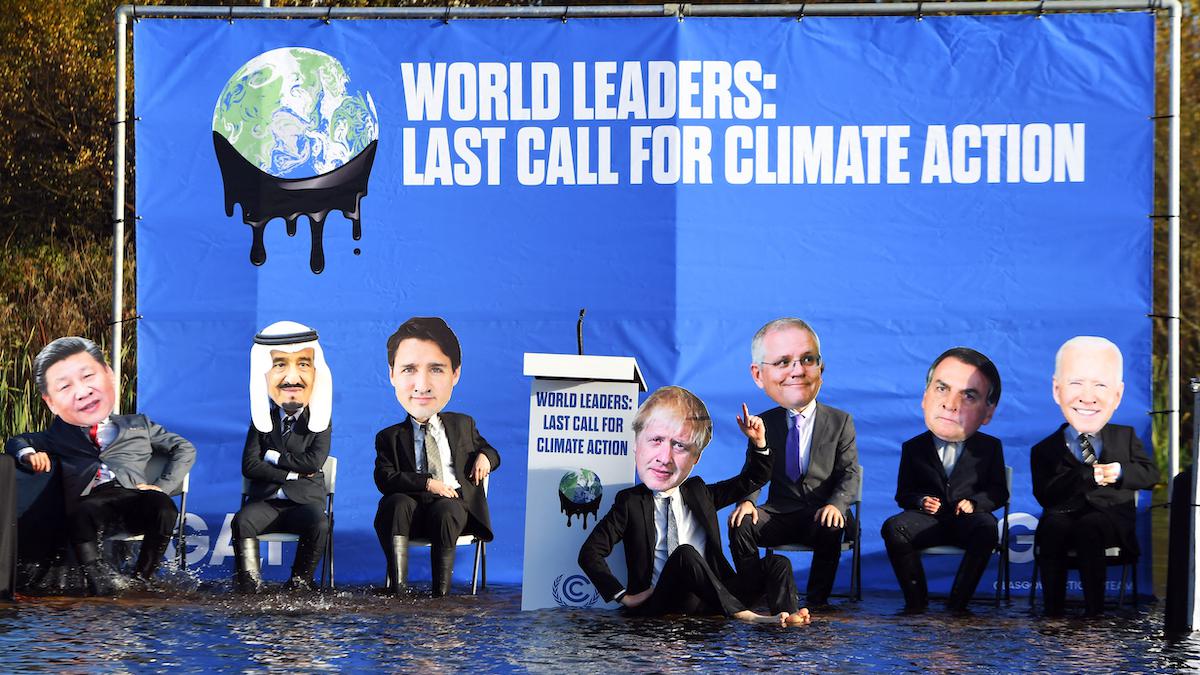 <wbr />Climate change activists dressed as world leaders pose for a photograph during a demonstration in Glasgow during COP26.