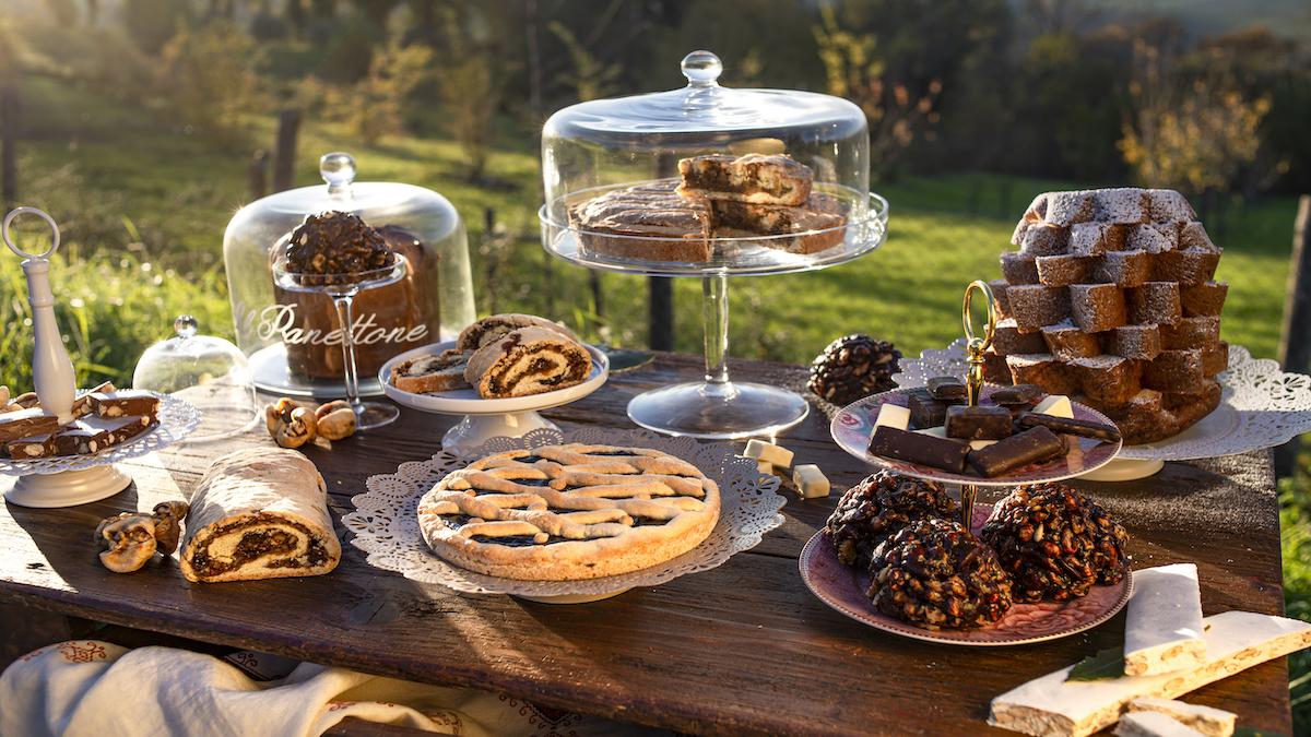 An assortment of holiday pies on an outside table.