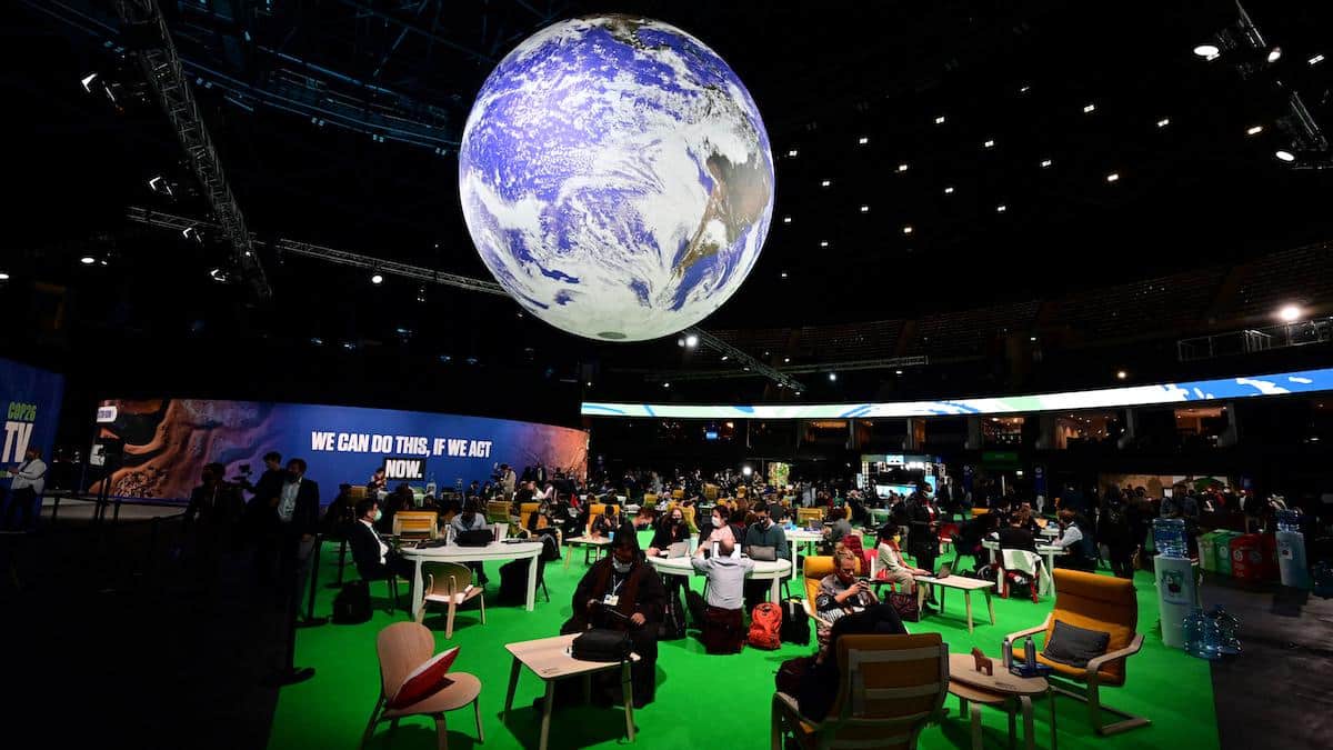​Delegates sit in the Action Zone at the COP26 UN Climate Summit.
