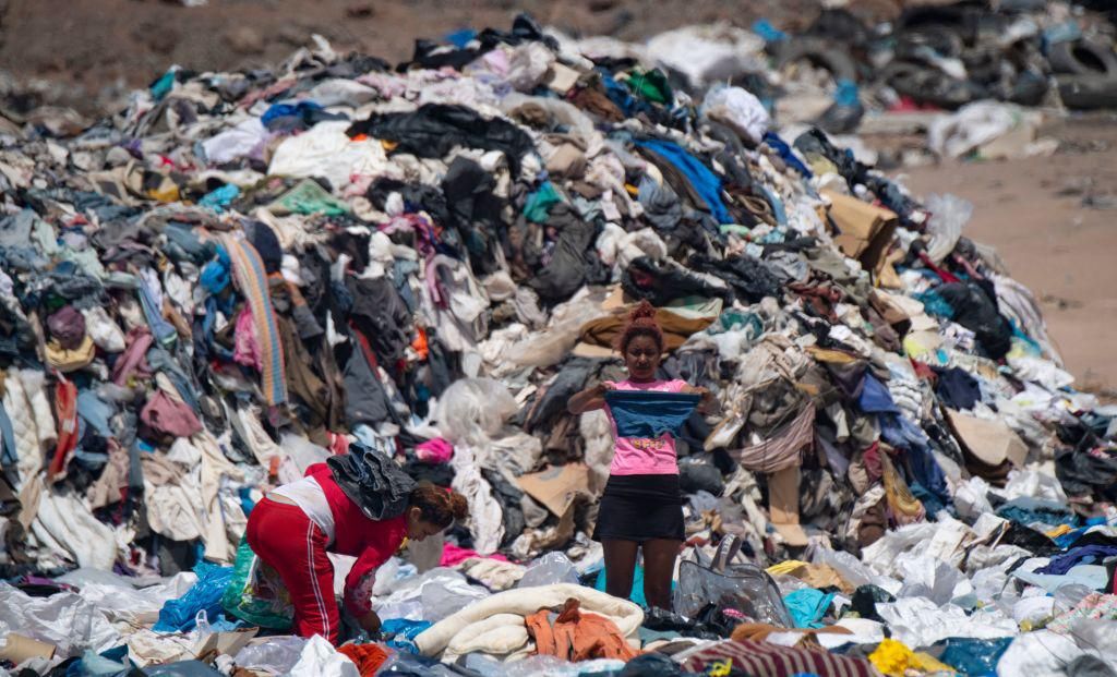 Women search for used clothes amid tons discarded in the Atacama desert, in Alto Hospicio, Iquique, Chile, 