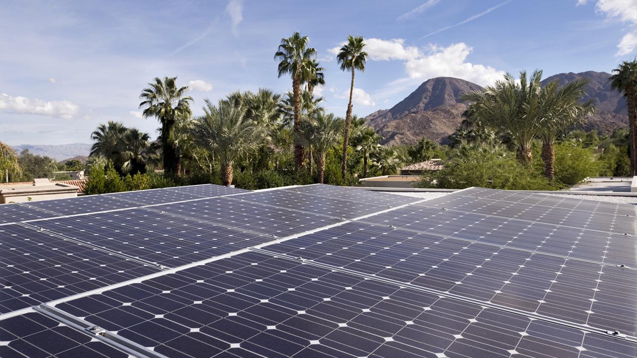 Wide angle image of a group of solar panels on top of a home in the city of Indian Wells, California.