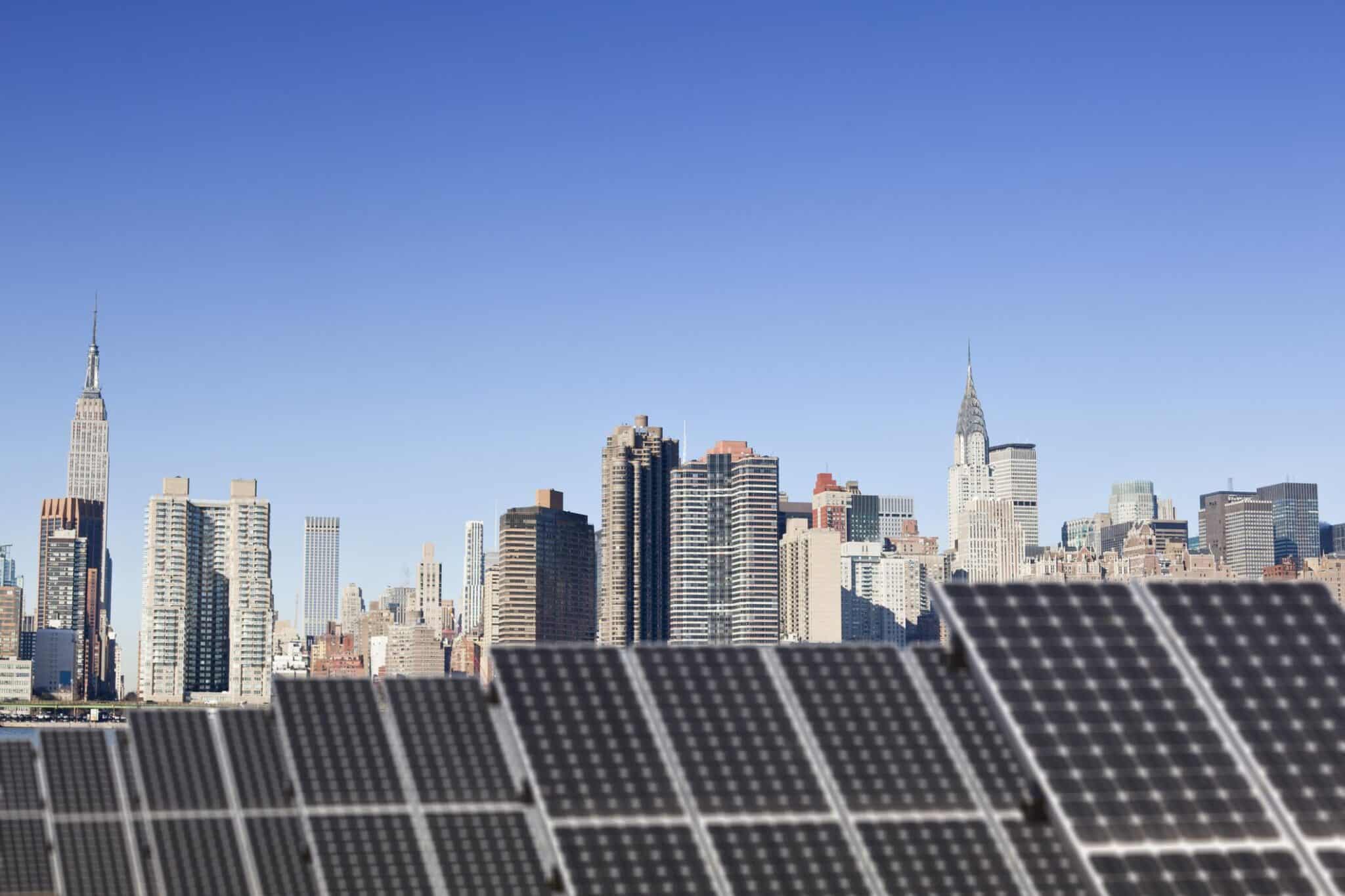 Roof top solar installation with Midtown Manhattan view as background, Chryler Building and Empire State Building