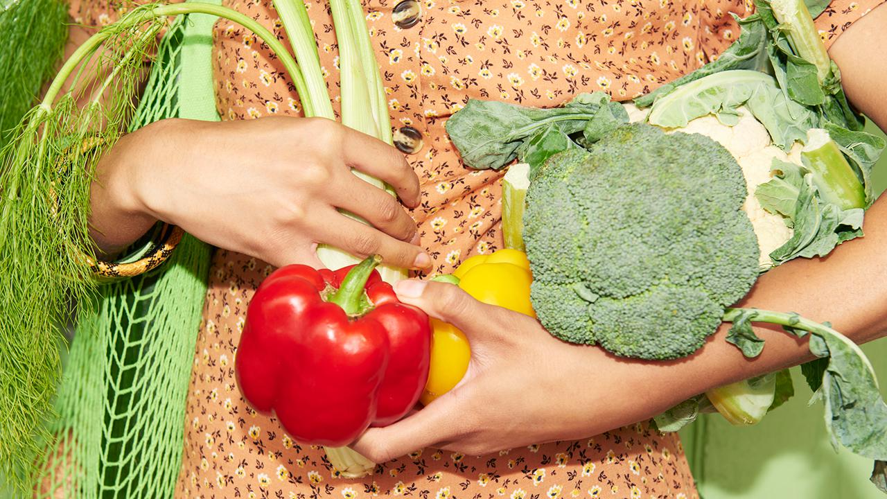 Close up of woman holding vegetables