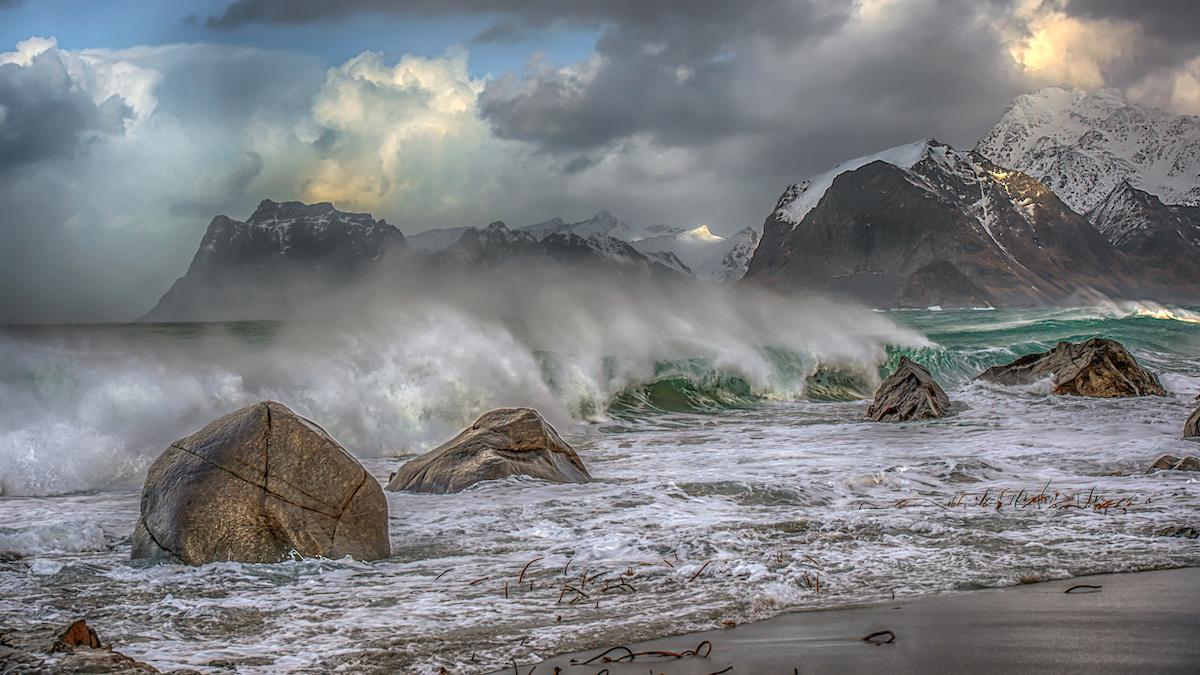 ​Waves crashing on a beach in Norway.