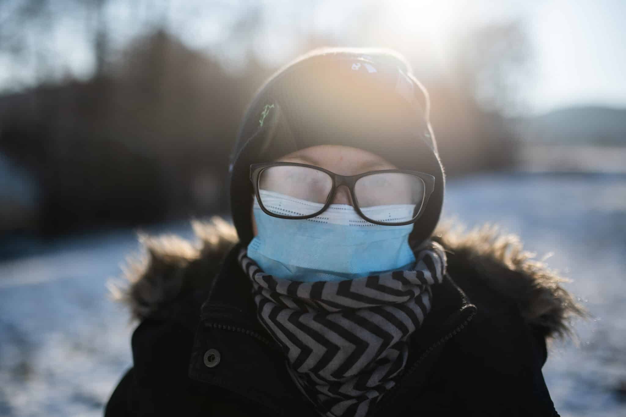 Woman Winter walk with face mask and fogged up eyeglasses
