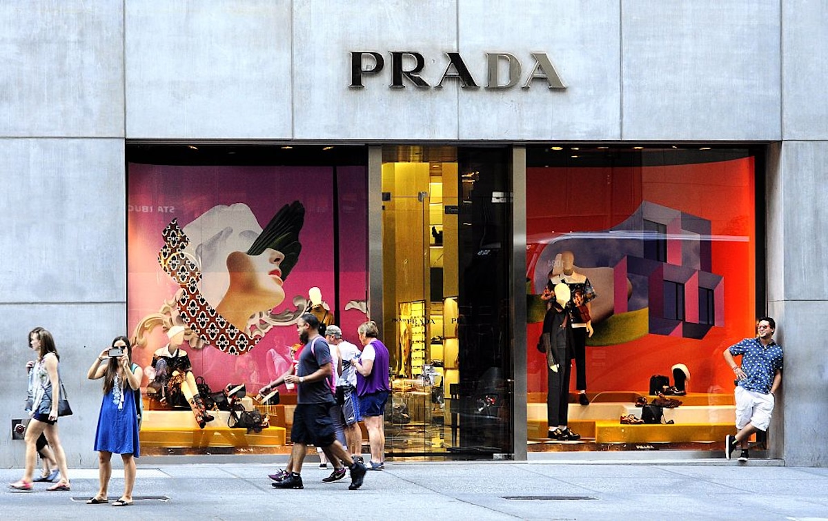 People walk past the Prada luxury fashion store in New York City.