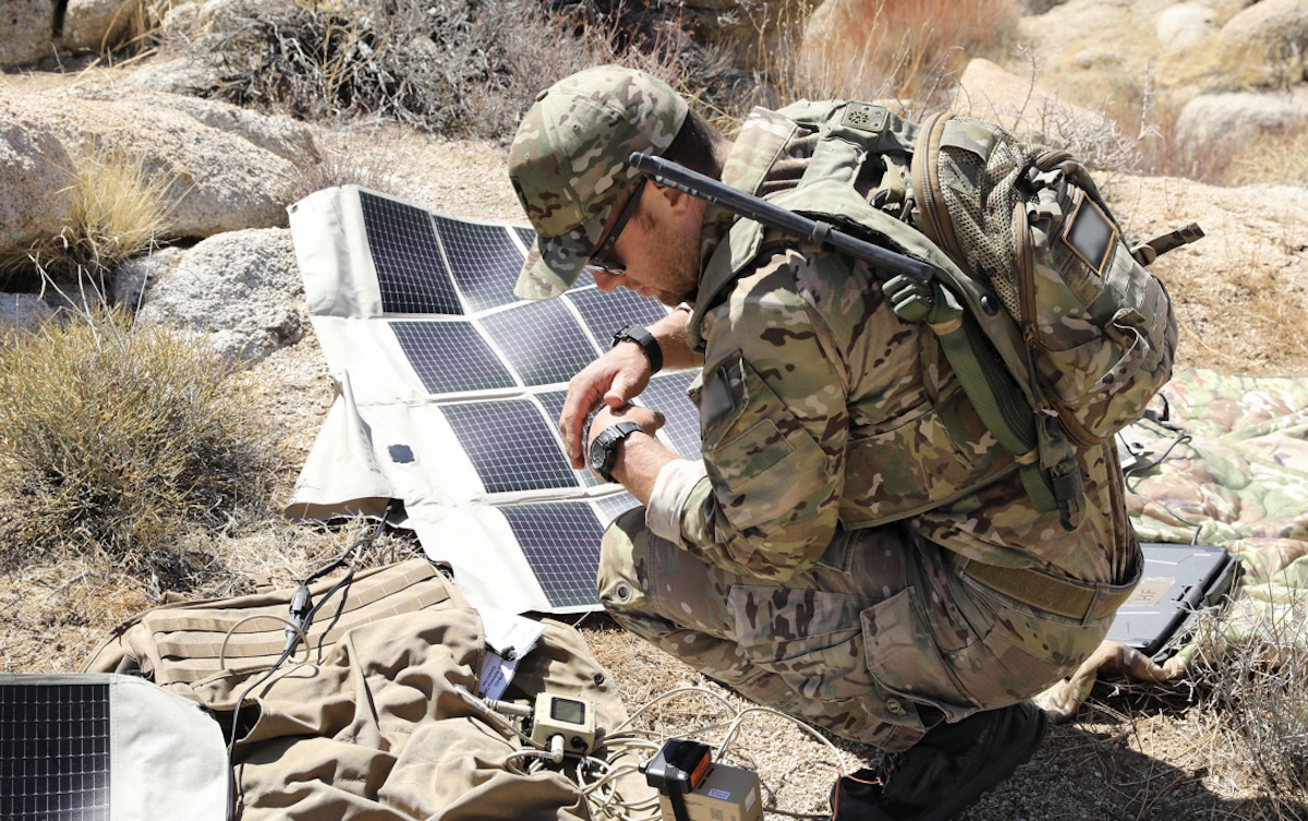 A U.S. Army soldier sets up solar panels