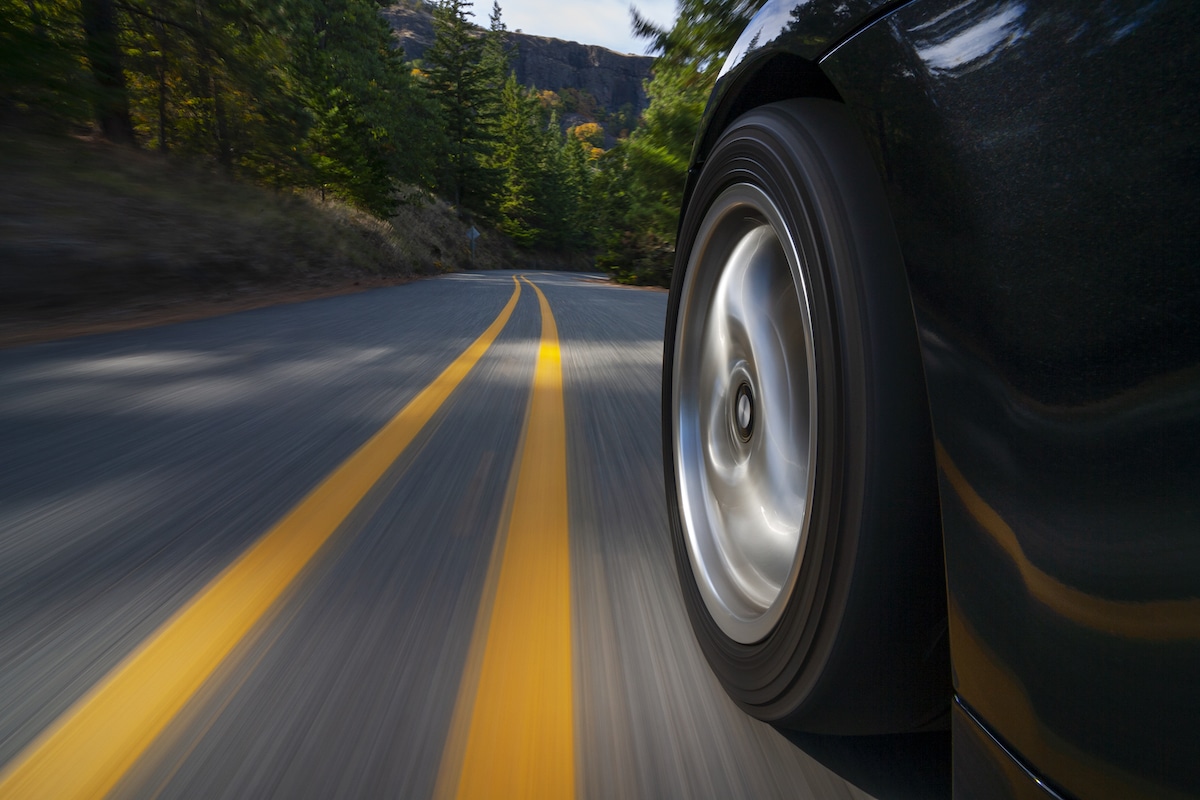 Closeup of a car tire on a road.