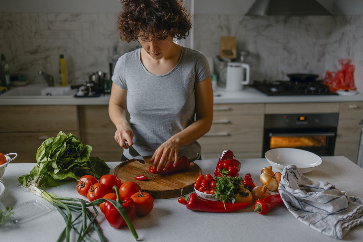 A woman prepares a plant-based meal.