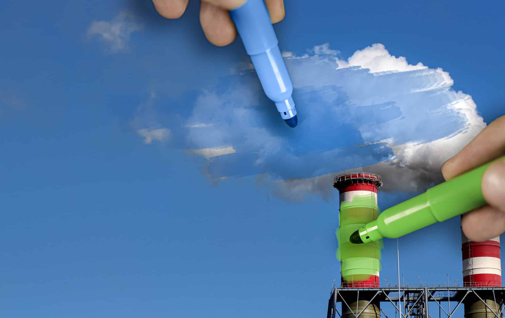 hands painting pollution blue and polluting chimneys green. Greenwashing malpractice concept