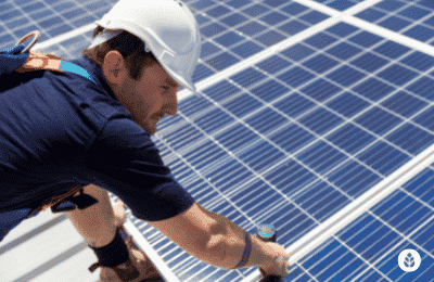 man tightening up solar panels
