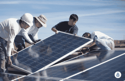 group of people installing solar panels