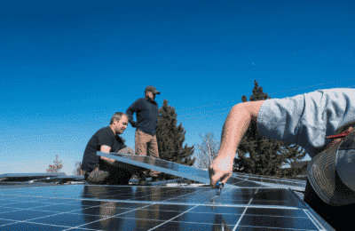group of people installing solar panels
