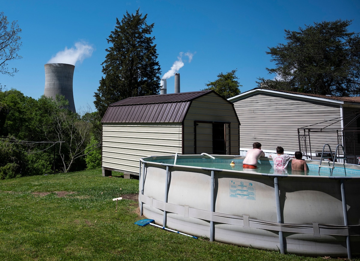 Young people in a backyard swimming people near a coal-fired power plant in Alabama