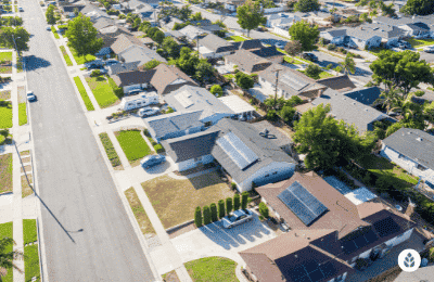 top view of a neighborhood with solar panels on the houses
