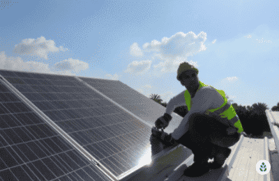 man inspecting a solar panel installation