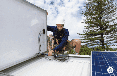 man connecting solar panels