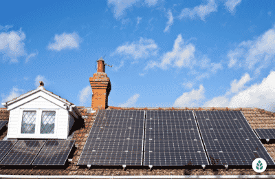 solar panels on a brick tile roof next to a window