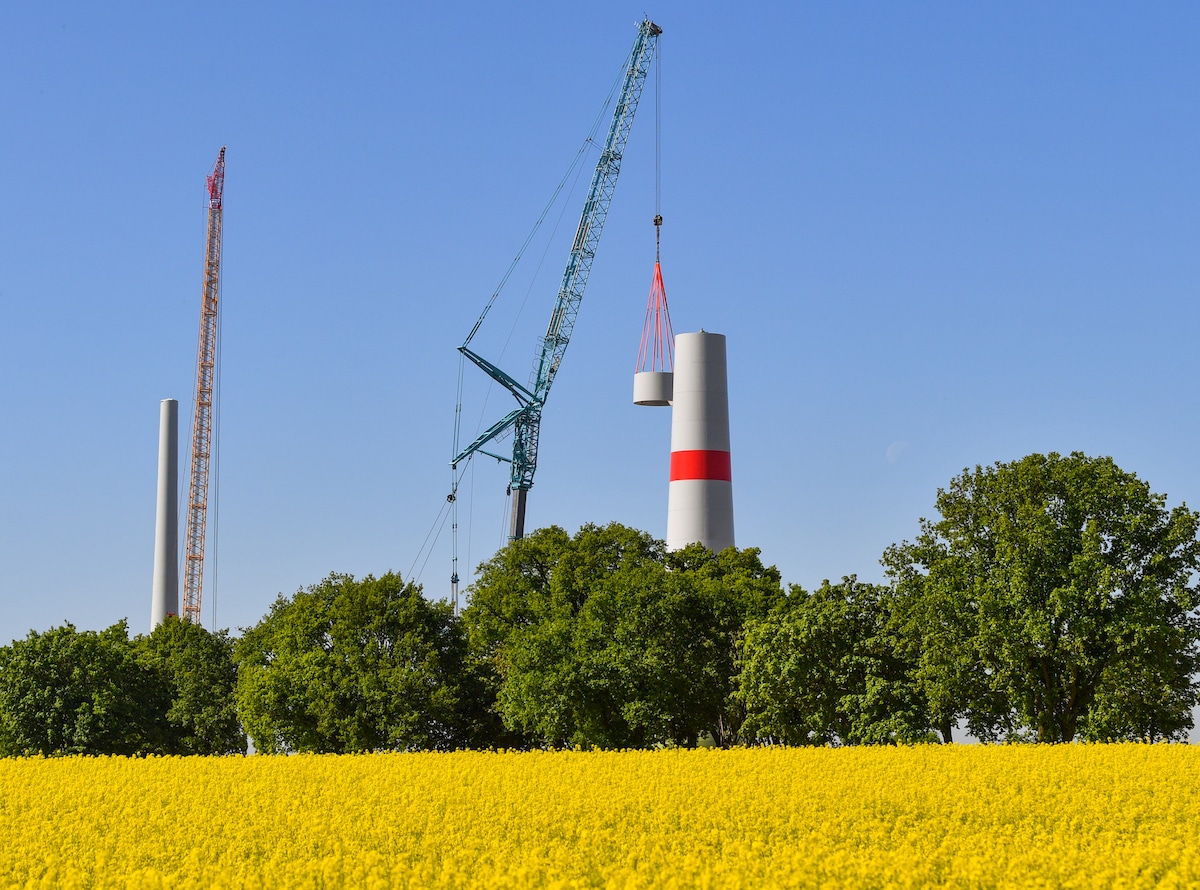 A segment is added during the construction of a new steel wind tower in Germany.
