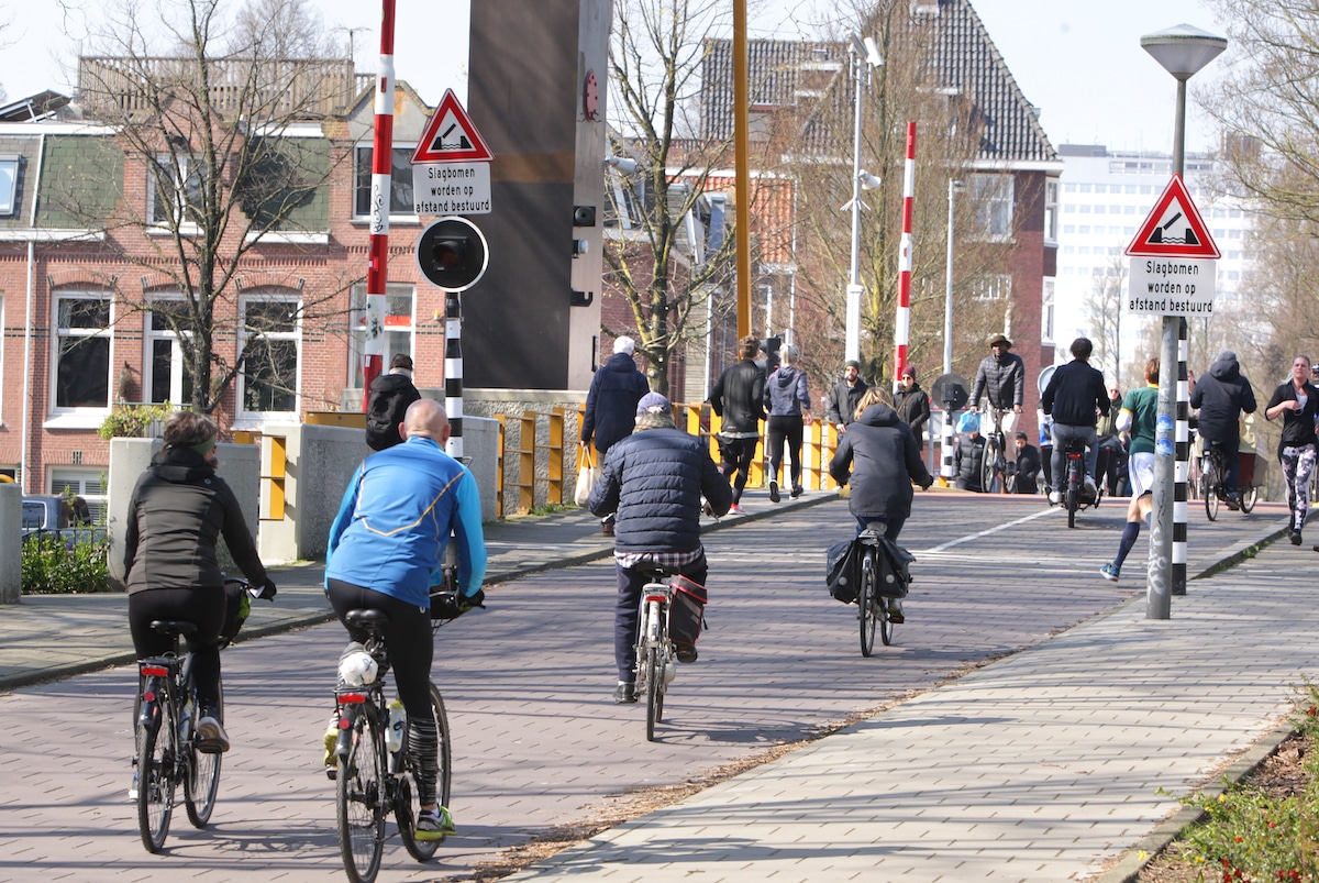 Cyclists and joggers in Amsterdam, the Netherlands