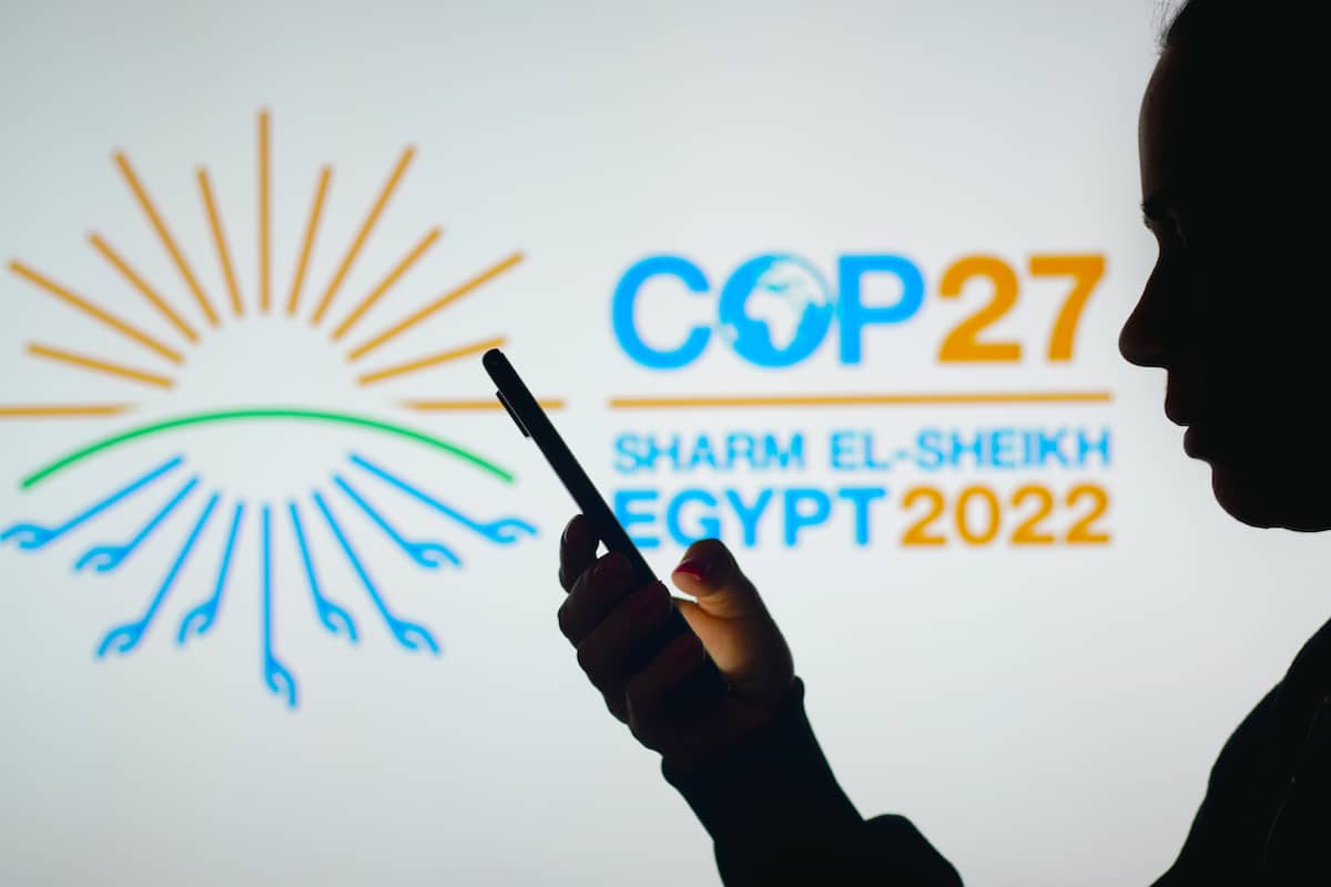 A banner says that COP27 will take place in Sharm El-Sheikh, Egypt