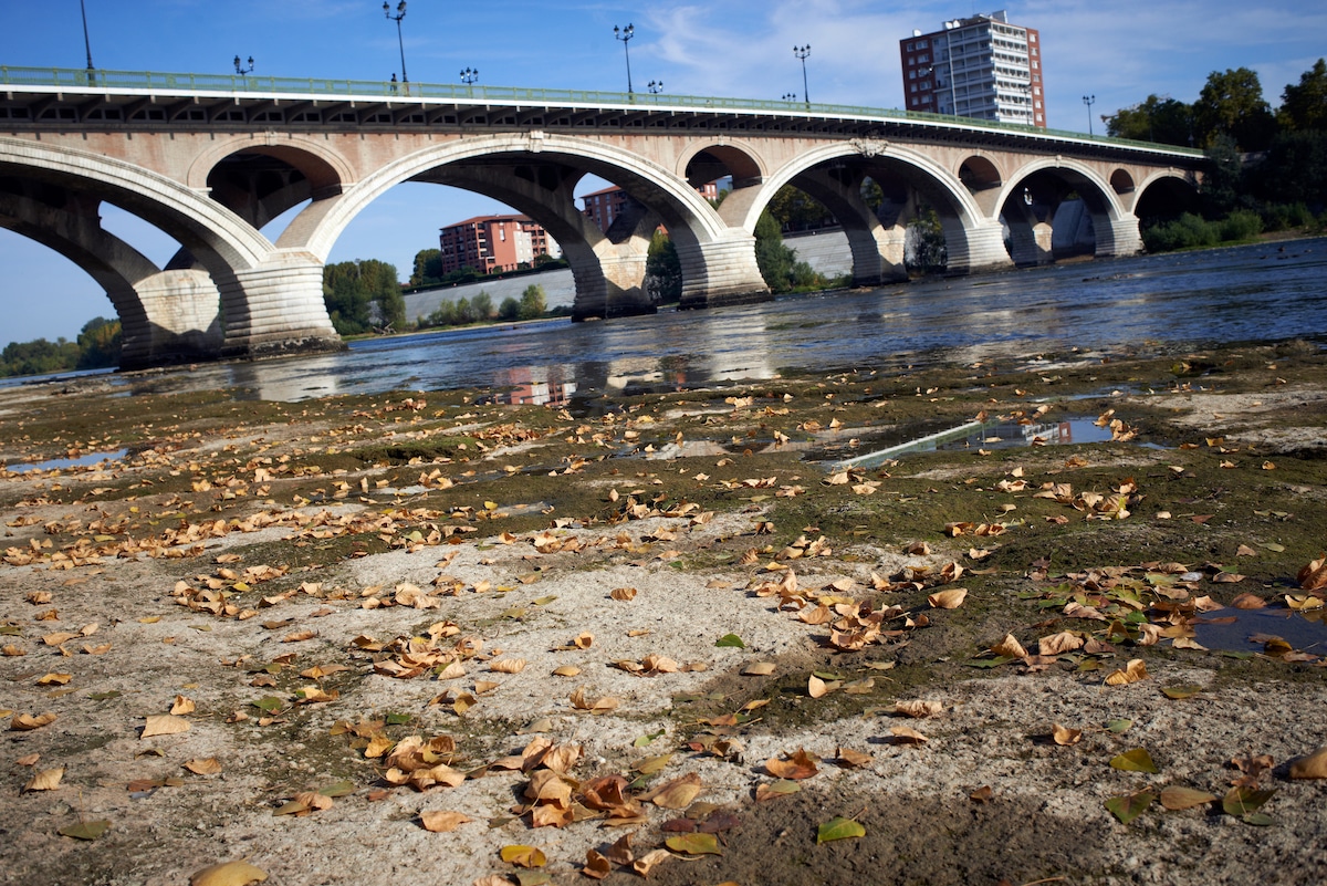 The drought-depleted riverbed of the Garonne River under the Pont Des Catalans bridge in Toulouse, France