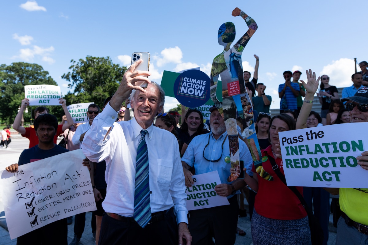 Senator Ed Markey shoots a selfie video with climate activists after the Senate passed the Inflation Reduction Act
