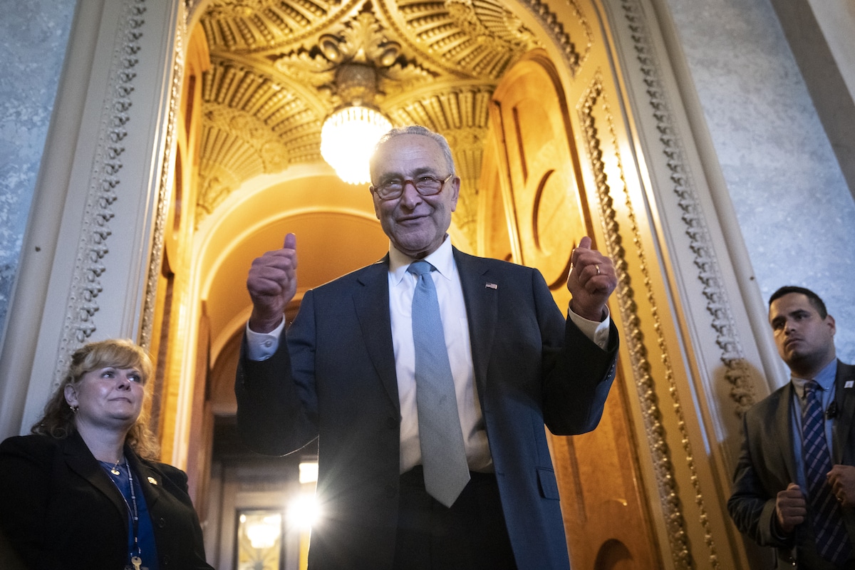 Senate Majority Leader Chuck Schumer gives the thumbs up as he leaves the Senate Chamber after passage of the Inflation Reduction Act
