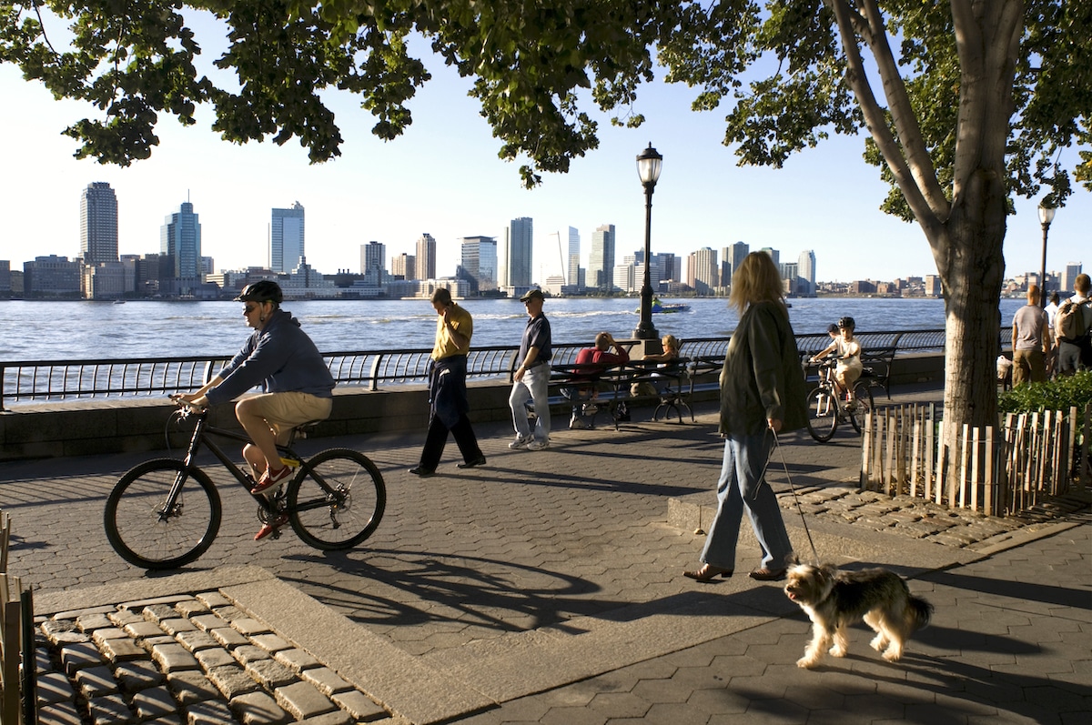 People walk and ride bicycles in Battery Park in New York