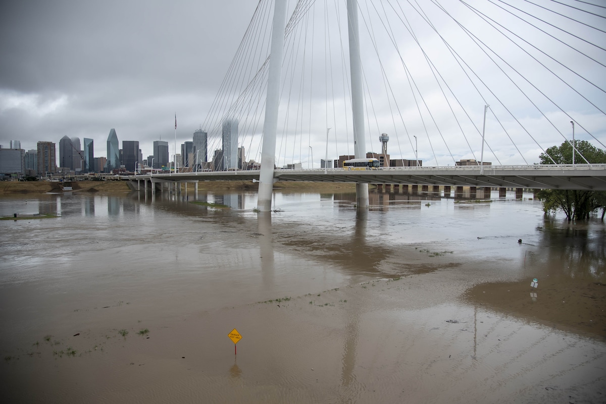 The Trinity River flows through a flooded area in Dallas, Texas