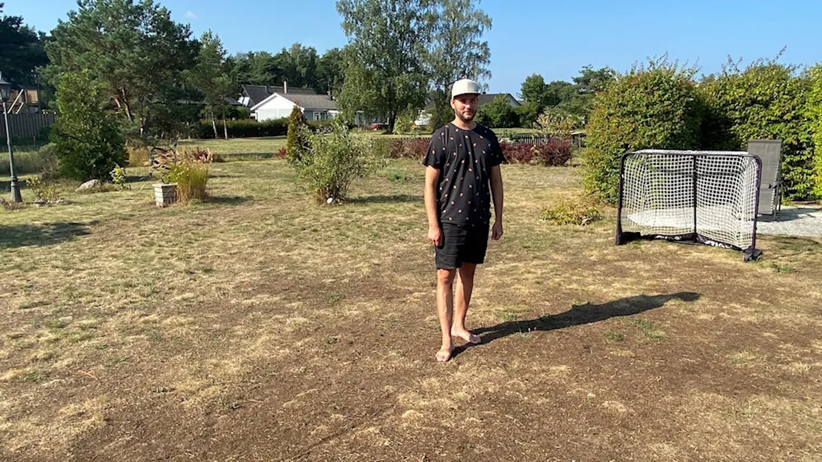 Marcus Norström stands on his winning "ugliest lawn" in Gotland, Sweden