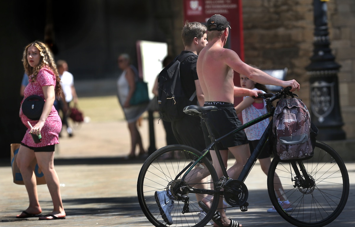 A bicyclist with no shirt and sunburn during a heat wave in July in Peterborough, UK