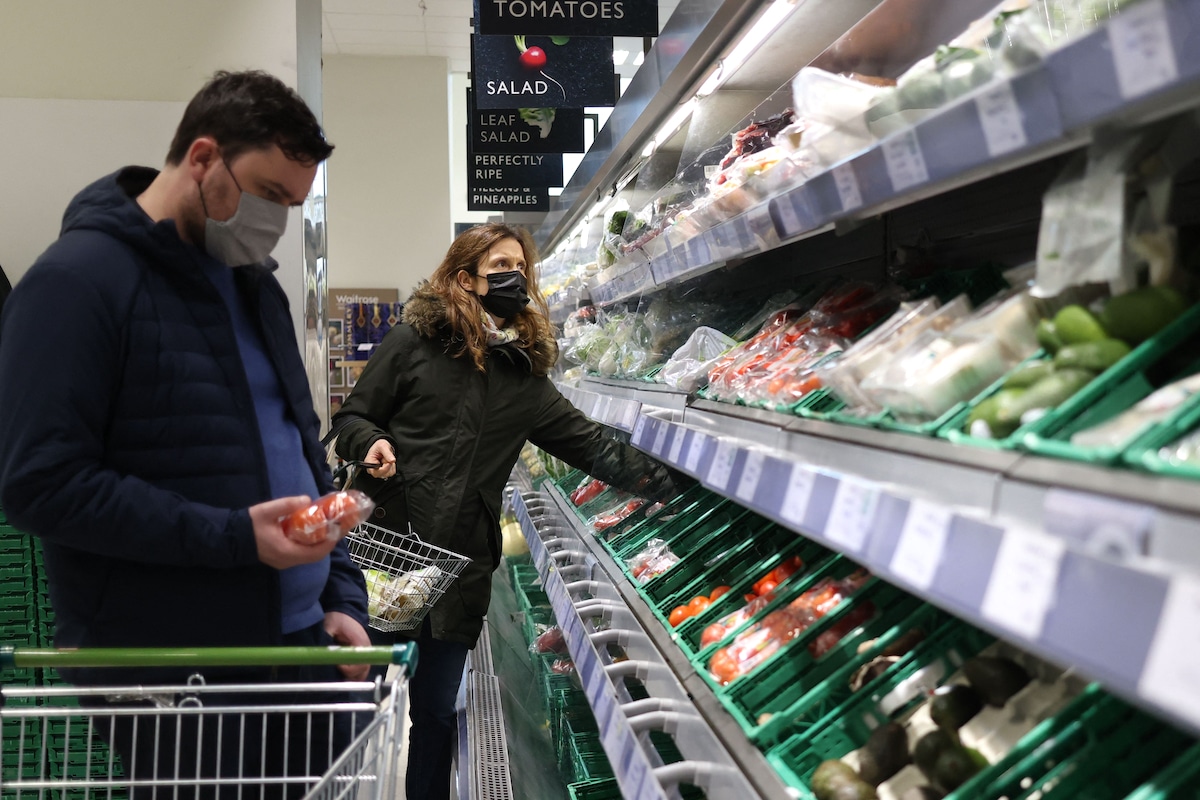 People shop for produce at a Waitrose supermarket in London