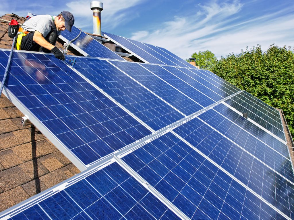Man installing solar panels on a North Carolina home