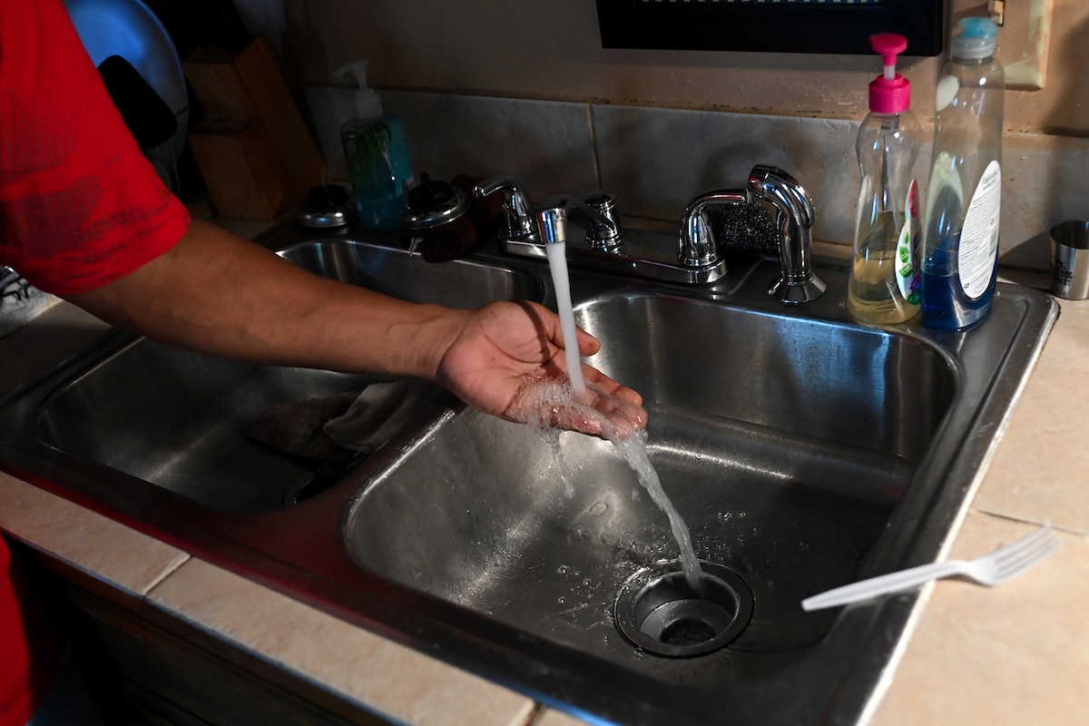 A Jackson, Mississippi resident checks the water in his kitchen