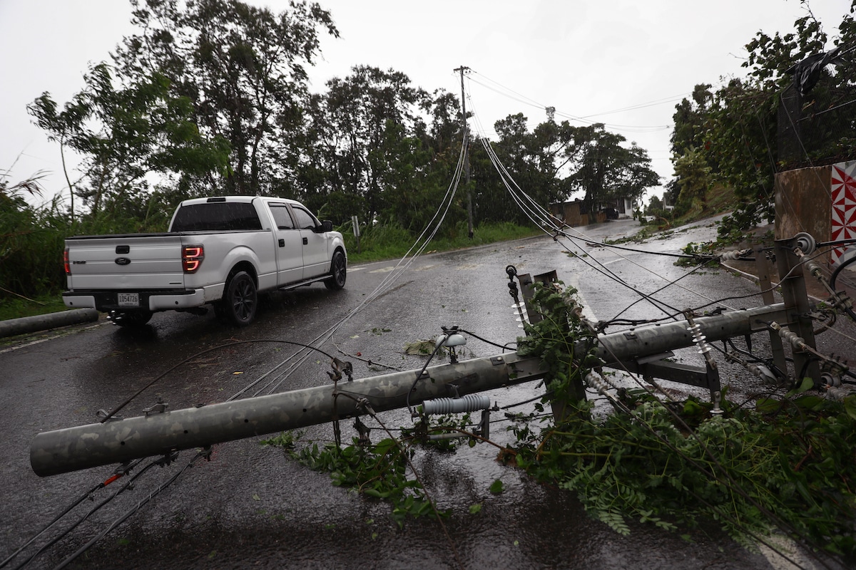 Downed power lines on a road in Puerto Rico after Hurricane Fiona struck the island