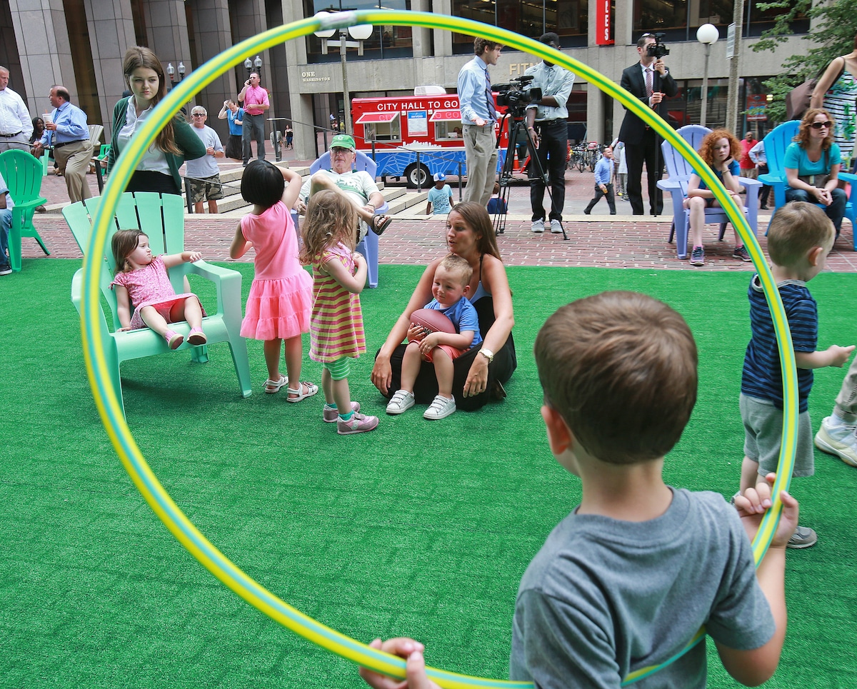 Boston Mayor Marty Walsh unveils an astroturf lawn where kids can play on City Hall Plaza in 2015