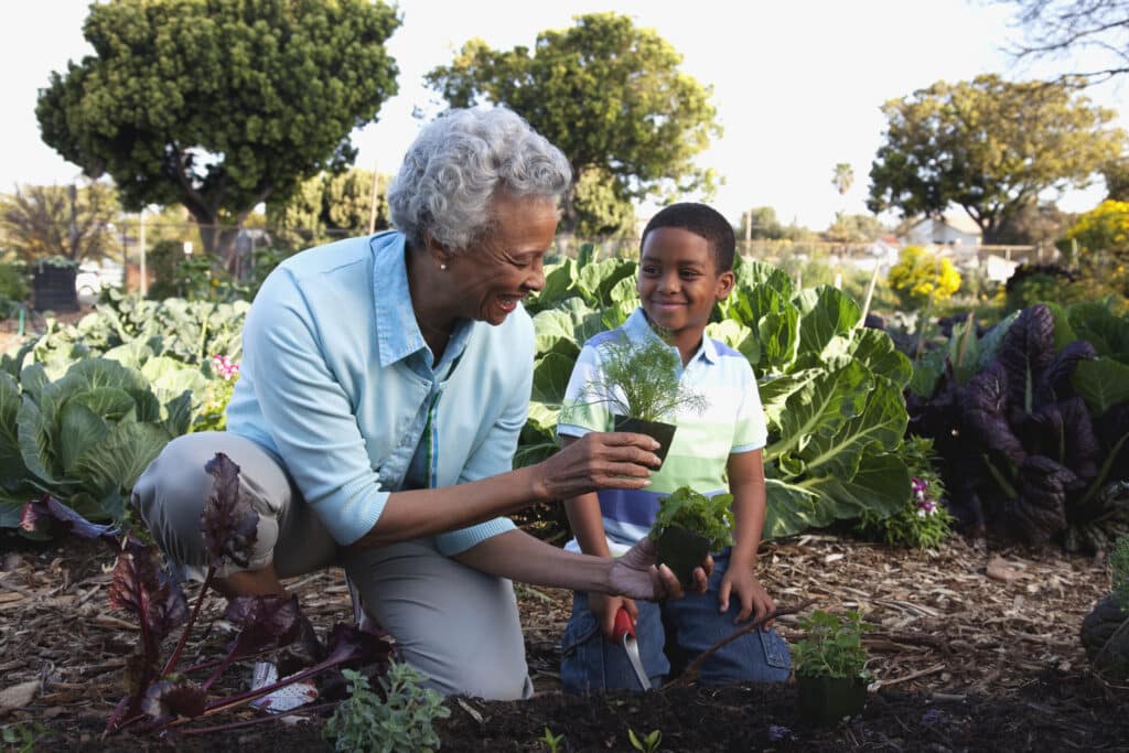 senior connects with child doing sustainable home activity of gardening